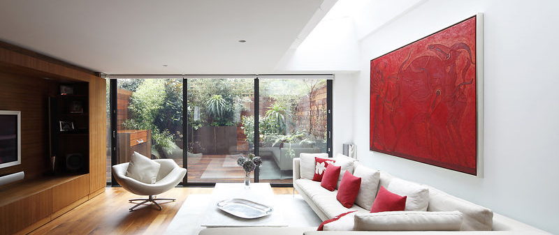 Contemporary living room with glazed doors to garden (lights off)